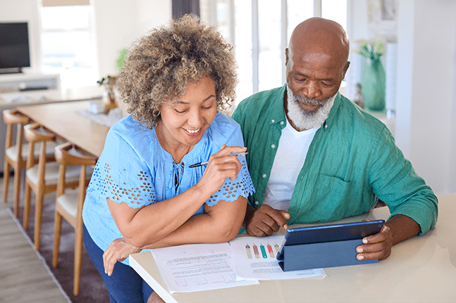 woman and man reviewing paperwork and charts