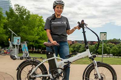 Person standing with an electric bike